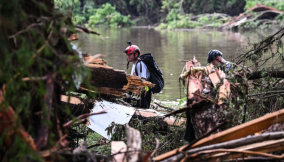 Members of a search and rescue team look for people near Camp Mystic in Hunt, Texas, on Saturday. Ronaldo SchemidtAFPGetty Images